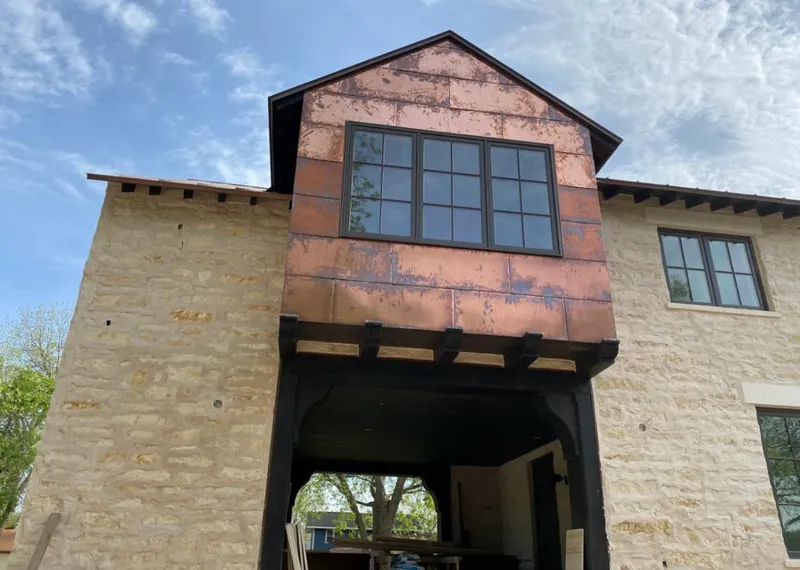 Copper metal panel facade on a stone building for Skylight Installation in Oregon