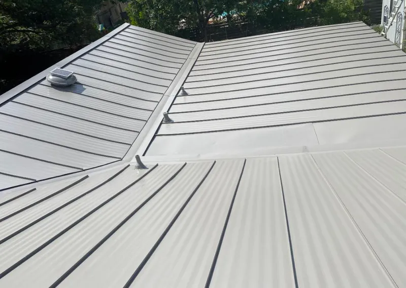 Solar attic fan installed on a metal roof for Roof Ventilation in Oregon