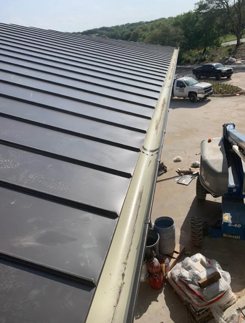 Standing seam panel and gutter detail on a metal roofing jobsite in Oregon
